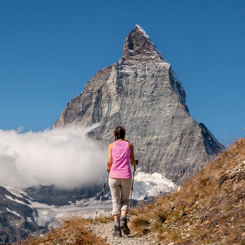 A trekker hiking towards the Matterhorn on the Walkers Haute Route Chamonix to Zermatt